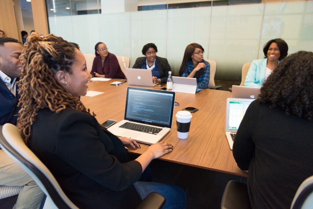 african american women sitting at a conference room table in a meeting
